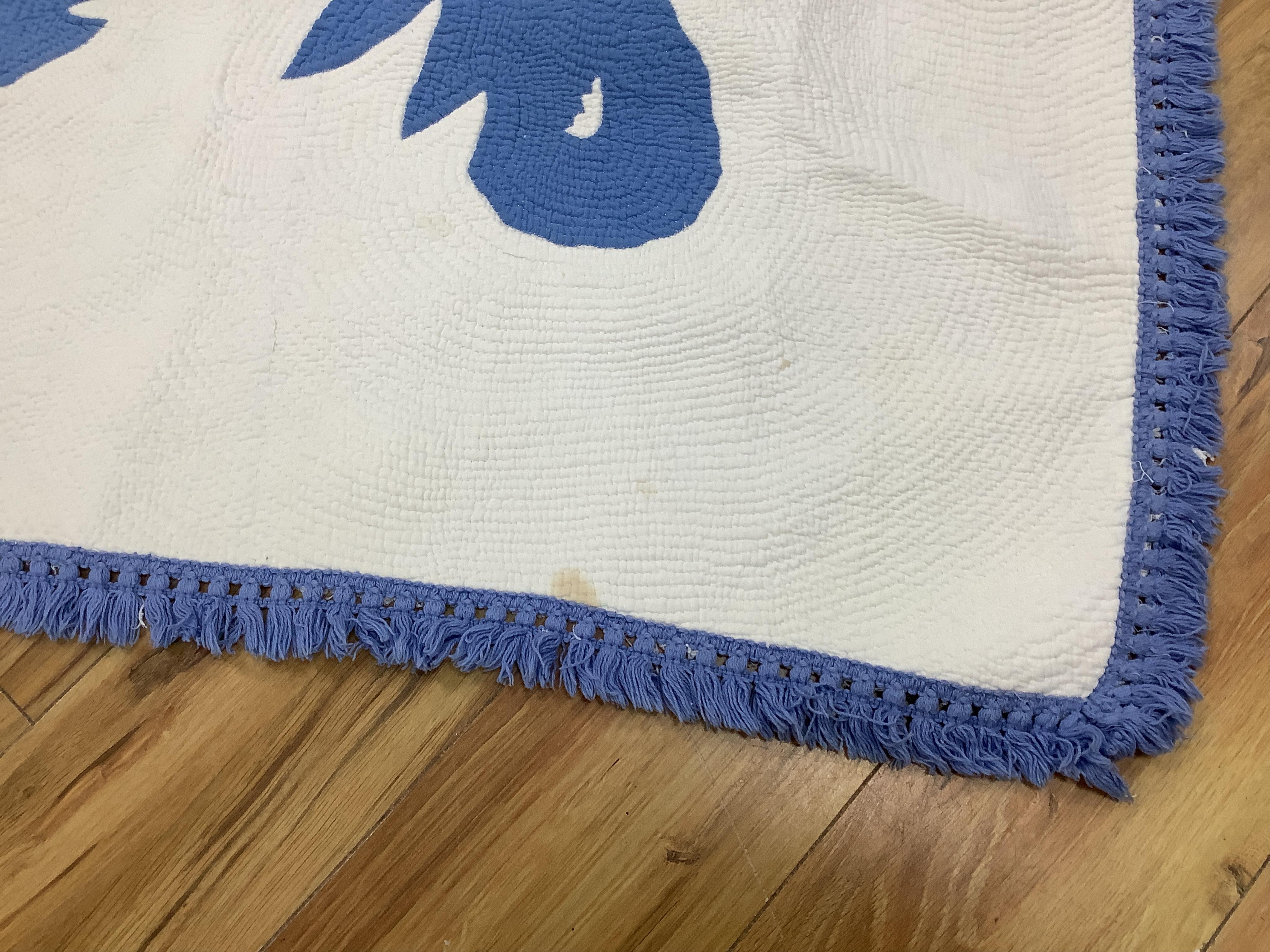 An American blue and white fringed bedcover (quilt)